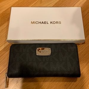Brand new Michael Kors zip around wallet. Black leather with grey MK design.